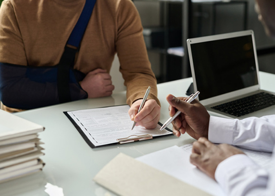 Criminal in Handcuffs Talking to Detective filling witness statement forms